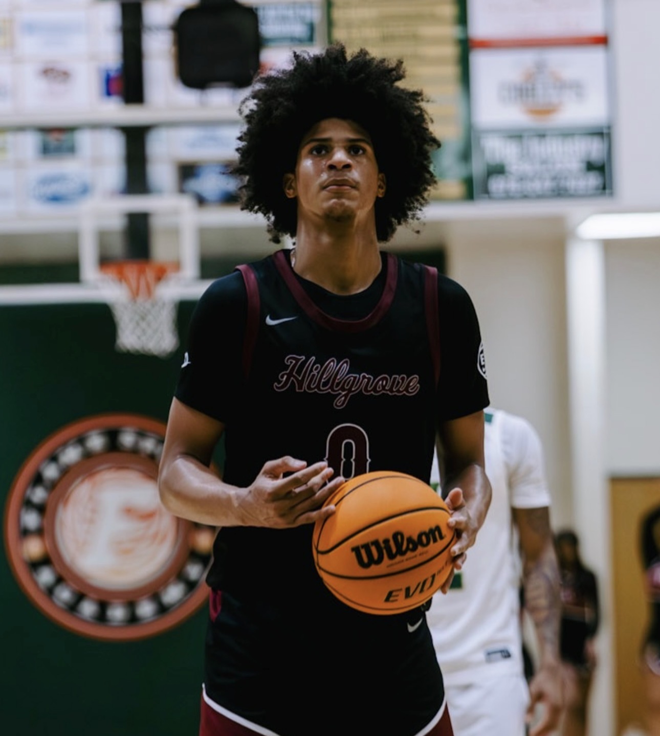 Asa Montgomery, five-star Class of 2027 forward from Hillgrove High School in Powder Springs, Georgia, at the free-throw line in his Hillgrove jersey after earning a North Carolina offer, USA Basketball U17 gold, and leading the Nike EYBL 17U circuit in scoring.